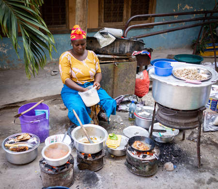 African woman cooking traditional food at streetの写真素材