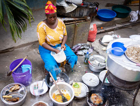 African woman cooking traditional food at streetの写真素材