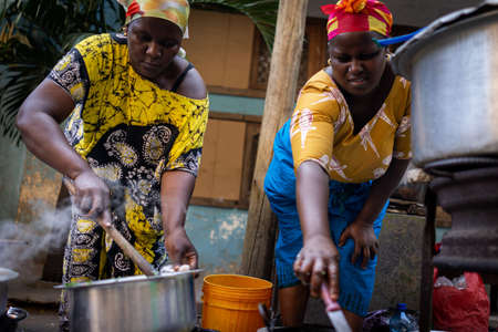 African woman cooking traditional food at streetの写真素材