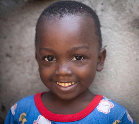 African black boy portrait standing near his poor house aloneの写真素材