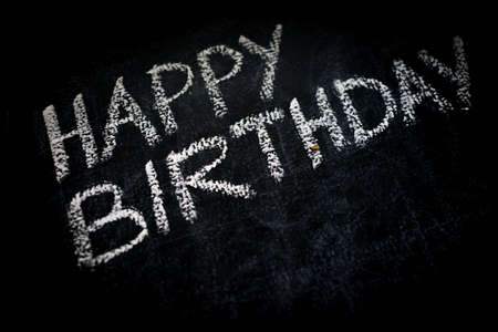 Happy birthday invitation message on black boardの写真素材