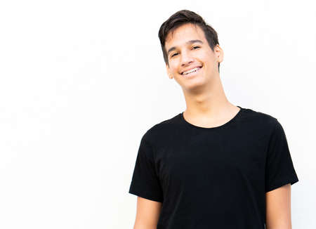 One positive teenage boy portrait against wallの写真素材