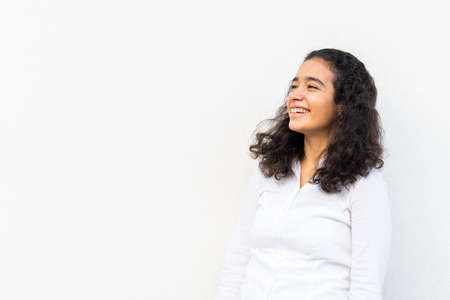 One positive woman portrait against the wallの写真素材