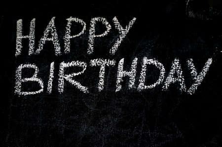 Happy birthday invitation message on black boardの写真素材
