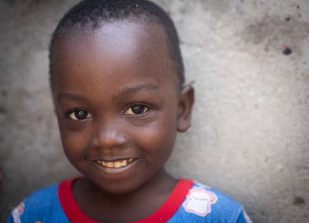 African black boy portrait standing near his poor house aloneの写真素材