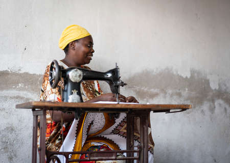 African female tailor working on sewing machineの写真素材