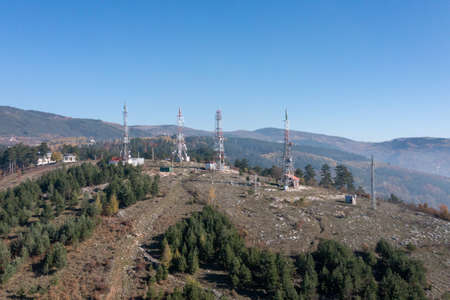 Telecommunications antenna tower in the morning. bright sunshine and blue sky with clouds. Transmitting antenna pairs. High quality photoの写真素材