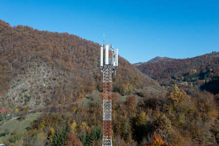 Telecommunications antenna tower in the morning. bright sunshine and blue sky with clouds. Transmitting antenna pairs. High quality photoの写真素材