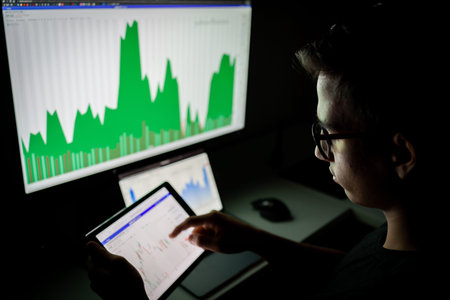 Crypto trader investor analyst looking at screen analyzing financial graph data on pc monitor, thinking of online stock exchange market investment .の写真素材