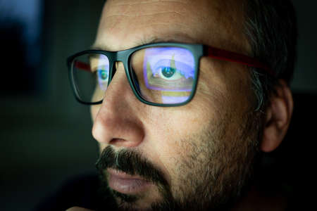 Crypto trader investor analyst looking at computer screen analyzing financial graph data on pc monitor, thinking of online stock exchange marketの写真素材