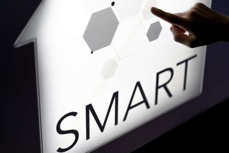 Man touching a smart home concept on a touch screen with his finger. High quality photoの写真素材