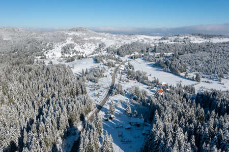 Car on road in winter trough a forest covered with snow. High quality photoの写真素材