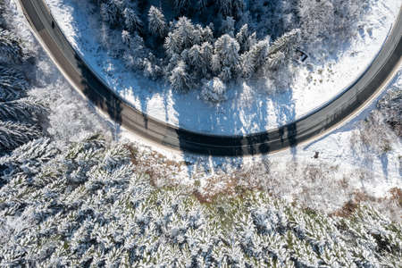 Car on road in winter trough a forest covered with snow. High quality photoの写真素材