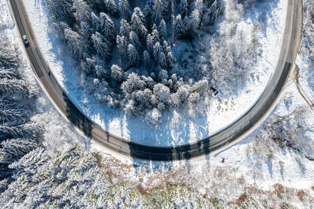 Car on road in winter trough a forest covered with snow. High quality photoの写真素材