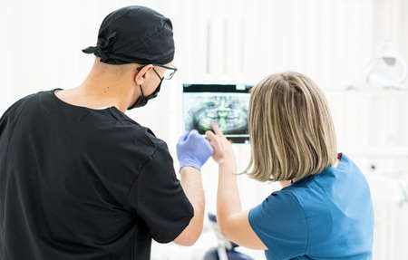 Two doctors checking x-ray image in hospital, quality photoの写真素材