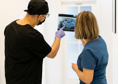 Two doctors checking x-ray image in hospital, quality photoの写真素材