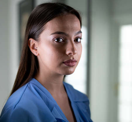 Beautiful young woman with mask inside hospital, high quality photoの写真素材