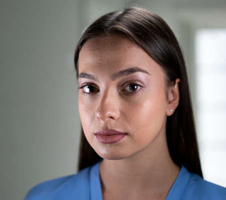 Beautiful young woman with mask inside hospital, high quality photoの写真素材