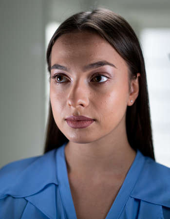 Beautiful young woman with mask inside hospital, high quality photoの写真素材