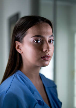 Beautiful young woman with mask inside hospital, high quality photoの写真素材