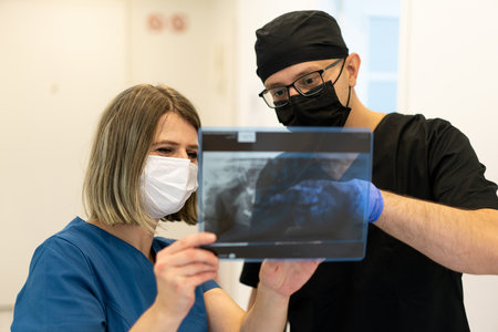Two doctors checking x-ray image in hospital, quality photoの写真素材