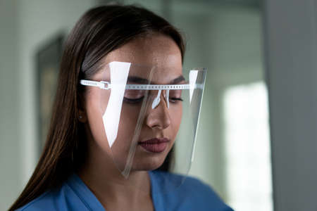 Beautiful young woman with mask inside hospital, high quality photoの写真素材