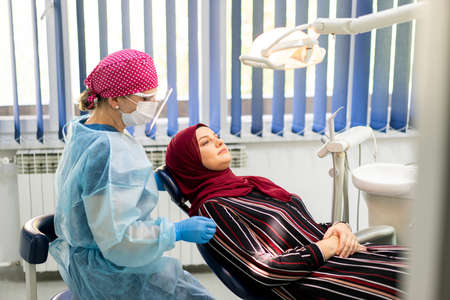 Muslim Middle Eastern girl inside dentist office. high quality photoの写真素材