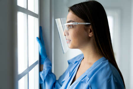 Beautiful young woman with mask inside hospital, high quality photoの写真素材
