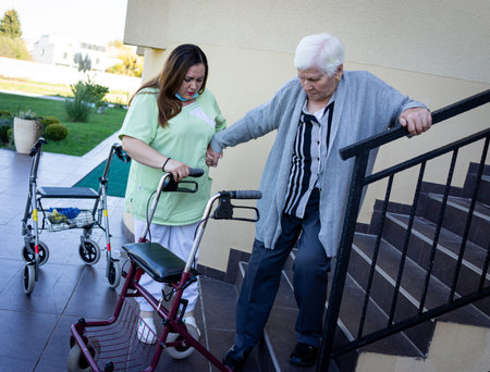 Senior disabled person in wheelchair needs nurse assistanceの写真素材