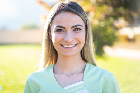 Portrait of the nurse with green uniform outdoorsの写真素材