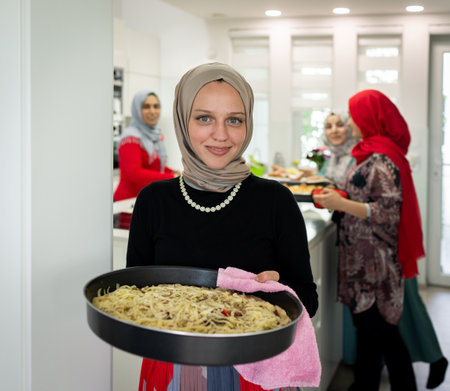 Muslim family and friends gathering together at home for eating dinner. High quality photoの写真素材