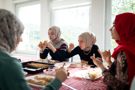 Muslim family and friends gathering together at home for eating dinner. High quality photoの写真素材