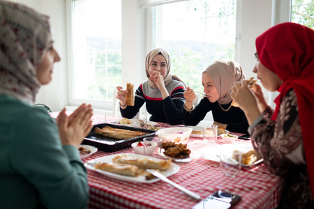 Muslim family and friends gathering together at home for eating dinner. High quality photoの写真素材