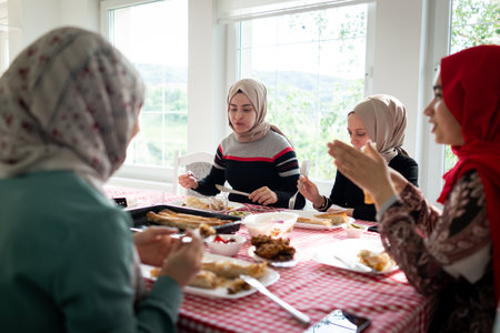Muslim family and friends gathering together at home for eating dinner. High quality photoの写真素材
