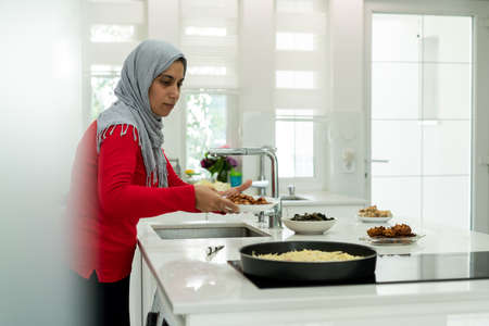 Muslim family and friends gathering together at home for eating dinner. High quality photoの写真素材