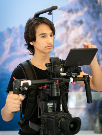 The camera man take photos and record video. Teenage boy learning.