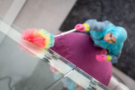 Happy Muslim Woman Cleaning Modern House Living Room. High quality photoの写真素材