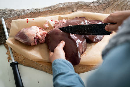 Beef raw heart on a background in woman hands. High quality photoの写真素材