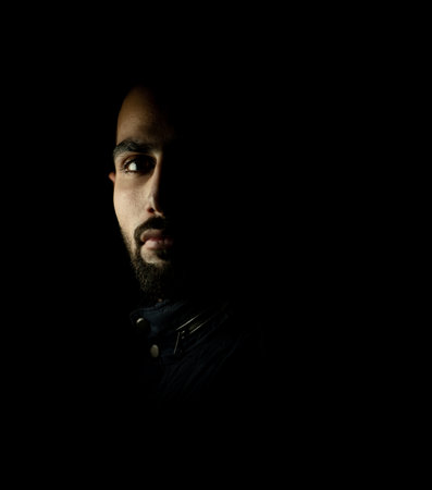 Portrait of young attractive man on a black background. High quality photoの写真素材