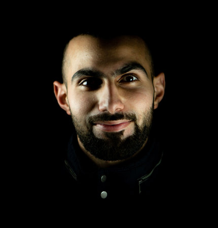 Portrait of young attractive man on a black background. High quality photoの写真素材