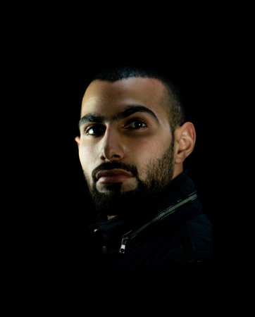Portrait of young attractive man on a black background. High quality photoの写真素材