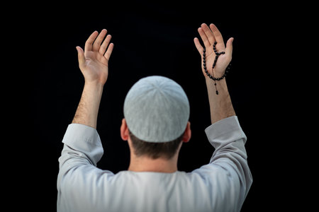 Muslim man standing and praying in the front of Kaaba in Mecca, KSAの写真素材