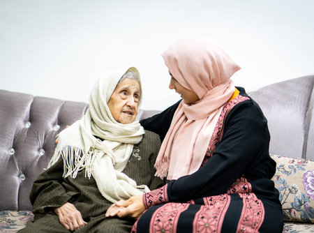 Portrait of woman hugging daughter with positive face. Third age, Home care concept. High quality...