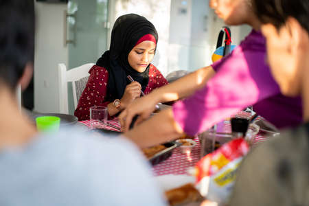 Mixed races friends and family gathering for eating dinner at home. High quality photoの写真素材