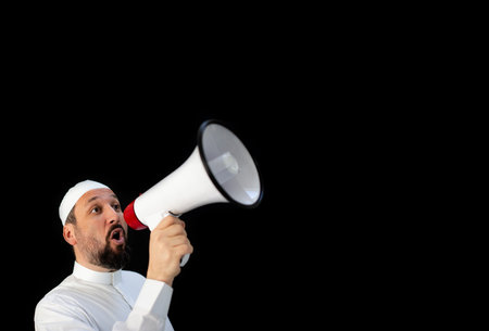 Handsome man with beard shouting through megaphone for Hajj in Mekkahの写真素材