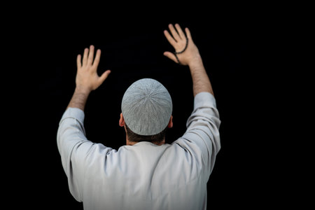 Muslim man standing and praying in the front of Kaaba in Mecca, KSAの写真素材