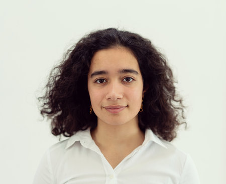 Beautiful young woman with black curly hair. High quality photoの写真素材