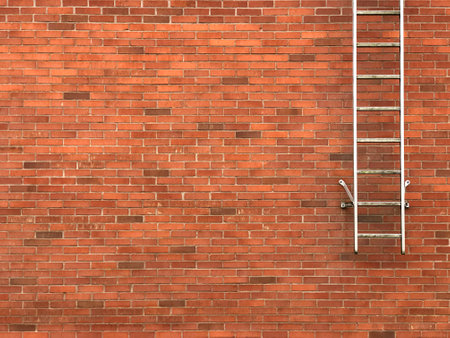 Safety exit ladders on brick wallの写真素材