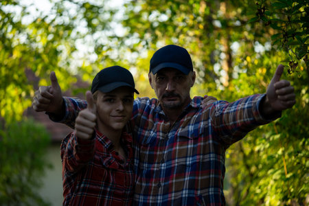 Father and son in green nature waiting for magic. Inquisitive childhood.の写真素材