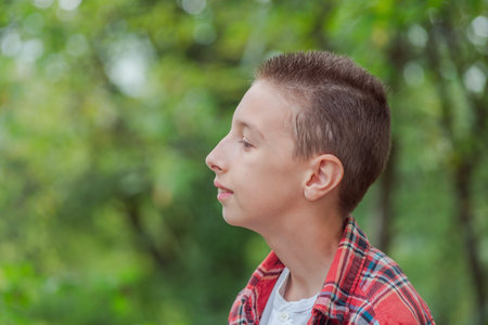 Cute little curious boy in green nature waiting for magic. Inquisitive childhood.の写真素材